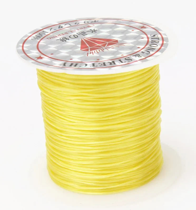 A spool of 10m multicolour elastic cord for beading and jewelry making, yellow in color.