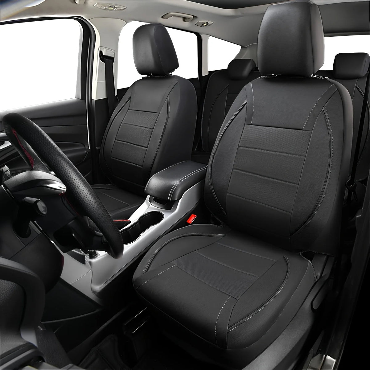 A front seat interior showing a driver's seat and passenger seat with black leather car seat covers.