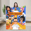 A colorful cartoon blanket featuring characters from Bob's Burgers, including Tina Belcher and Bob Belcher.