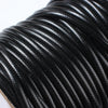 A close-up of black waxed cord rope used for jewelry making and crafting.