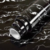 Roll of waterproof self-adhesive marble wallpaper with black and white veining on a dark surface