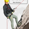 A man wearing a yellow helmet and climbing gear is shown using a red rope on a rocky cliff face.