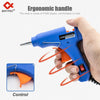 A hand holds a blue hot melt glue gun, demonstrating the ergonomic handle and control features.