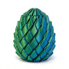 A vibrant teal green dragon twist egg stress reliever with a textured, scale-like surface.