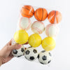 A clear plastic bag contains a set of soft foam sports stress balls in orange, white, and yellow colors.