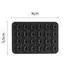 Black silicone suction pads for phone mounts arranged in a grid.