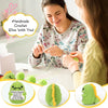 A woman is shown crocheting a dinosaur toy with a positive message card, surrounded by finished green crochet animals.
