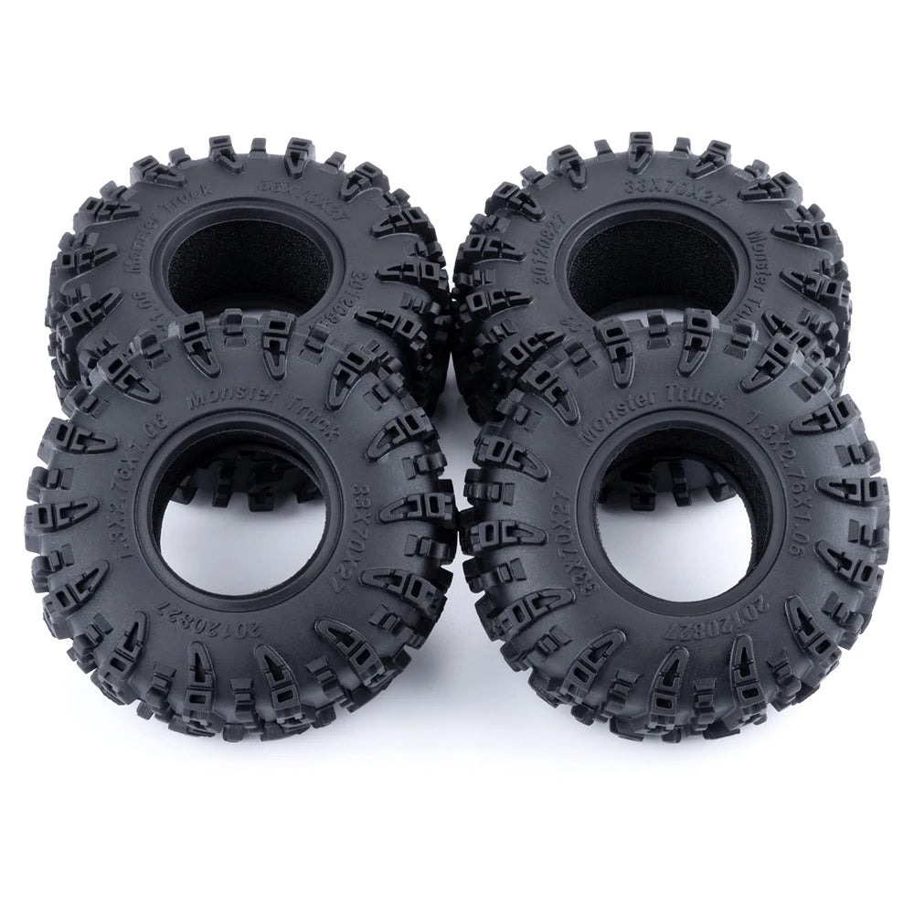 A pair of black mud terrain wheels and tires for RC crawlers.
