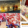 A display of transparent PVC gift tote bags with hand loops in various colors and patterns.