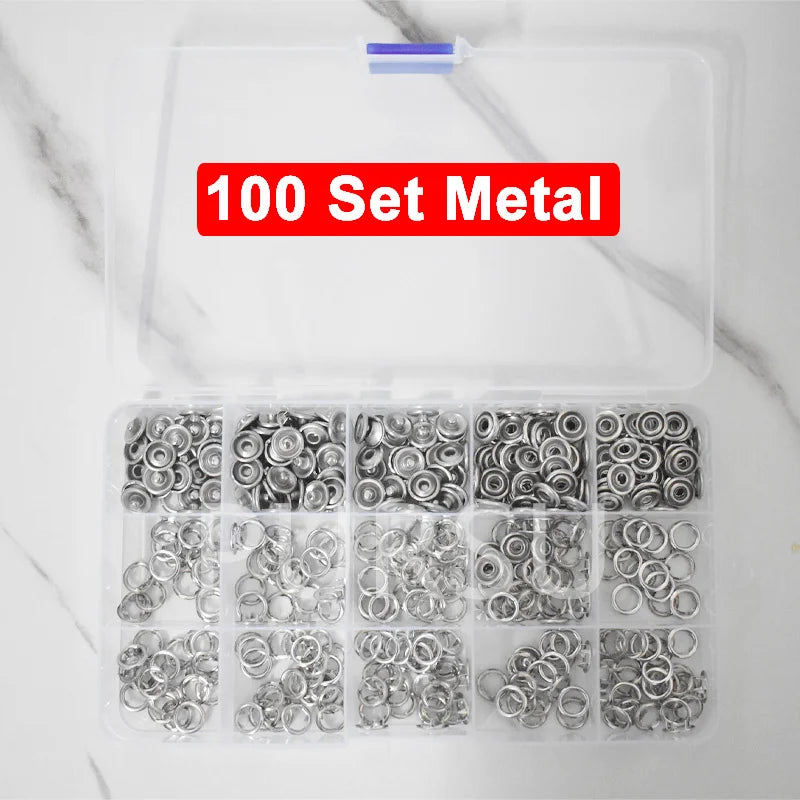A clear plastic container holding 100 sets of metal snap buttons for clothing, bags, and DIY crafts.