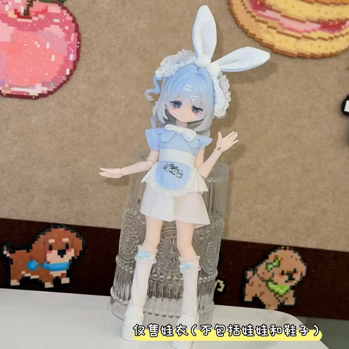 A light blue BJD doll dressed in a sweet maid outfit with white frills and a bunny ear headband.