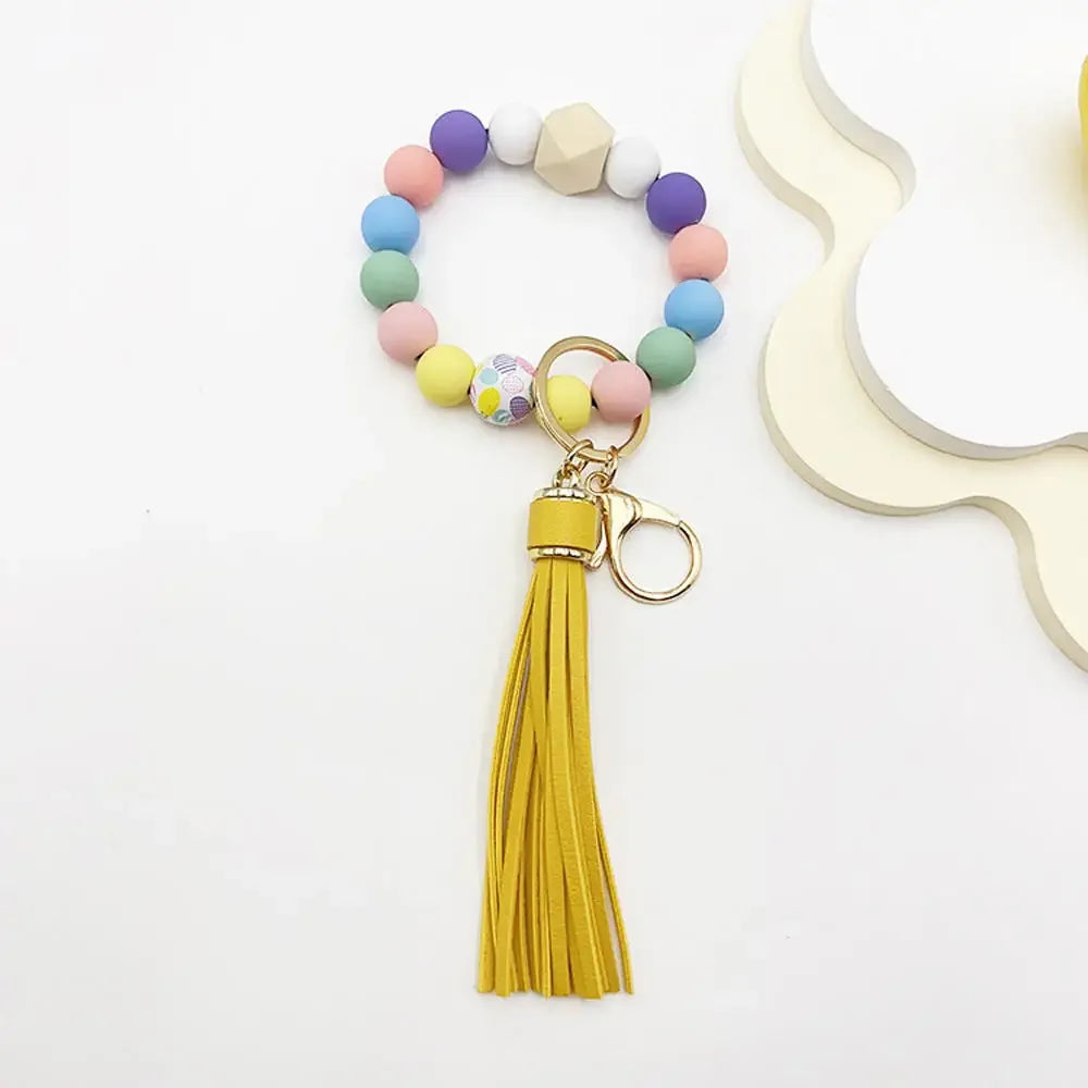 Boho silicone bead keychain featuring multicolored round beads and a yellow tassel