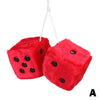 A red plush velvet dice pendant with black dots, suspended by a white string.