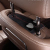 A close-up of a car seat headrest with dual metal hooks designed for hanging bags or phones.