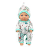 A baby doll wearing a light green and white dinosaur-themed jumpsuit outfit.