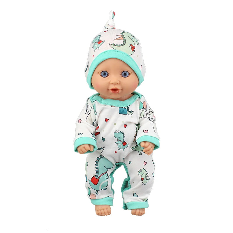A baby doll wearing a light green and white dinosaur-themed jumpsuit outfit.