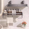 A wall-mounted shower caddy with suction cups holds various skincare bottles and a white towel on a gray wall.