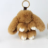 A fluffy brown bunny keychain featuring a pom pom tail and white paws.