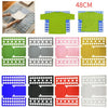 A set of plastic clothes folding boards in various colors and sizes for folding shirts and t-shirts.