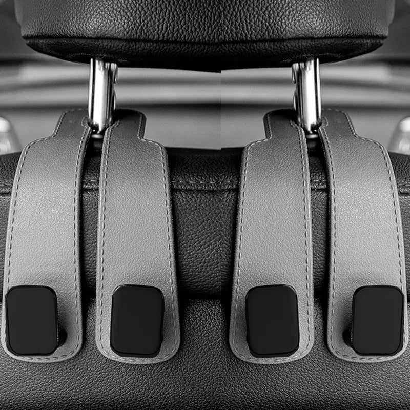 Close-up view of car headrest hooks designed for hanging bags and shopping organizers