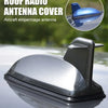 A silver roof radio antenna cover for an aircraft empennage antenna is shown on a car windshield.