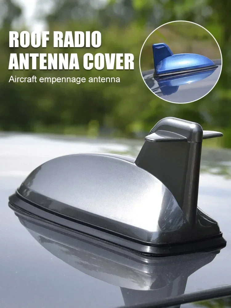 A silver roof radio antenna cover for an aircraft empennage antenna is shown on a car windshield.