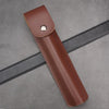 A brown leather holster for a manual wood auger drill, shown diagonally on a gray surface.