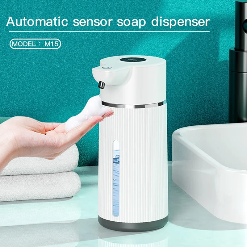 A white automatic sensor soap dispenser is shown next to a toilet, with a hand dispensing soap.