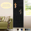 A dark gray self-adhesive cat scratching mat protector is shown on a wall, with cats visible on the mat and a green sofa near