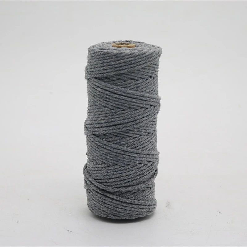 A spool of gray macrame cord, 3mm/4mm thickness, used for crafting.