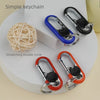 A set of simple keychain locks including a ball-shaped item and double circle carabiners in blue and orange.