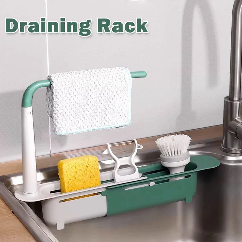 A draining rack holding a white towel and yellow sponge in a kitchen sink.
