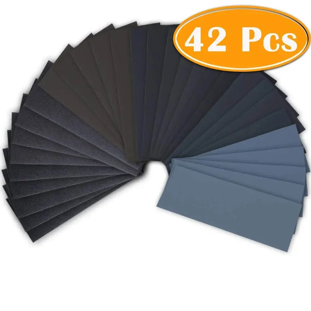 A fan arrangement of 42 pieces of wet and dry sandpaper in various shades of gray and black.