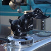 Black resin angry duck hood ornament displayed on a reflective surface.