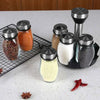 A set of rotating glass spice jars with a rack, showing various ground spices and salt.