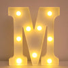 A glowing yellow LED letter M night light for home and party decor.