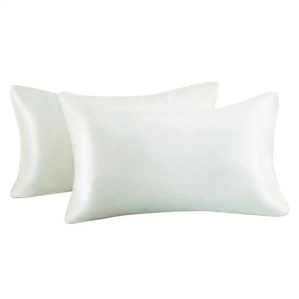 A set of two white silky satin pillowcases for hair and skin.
