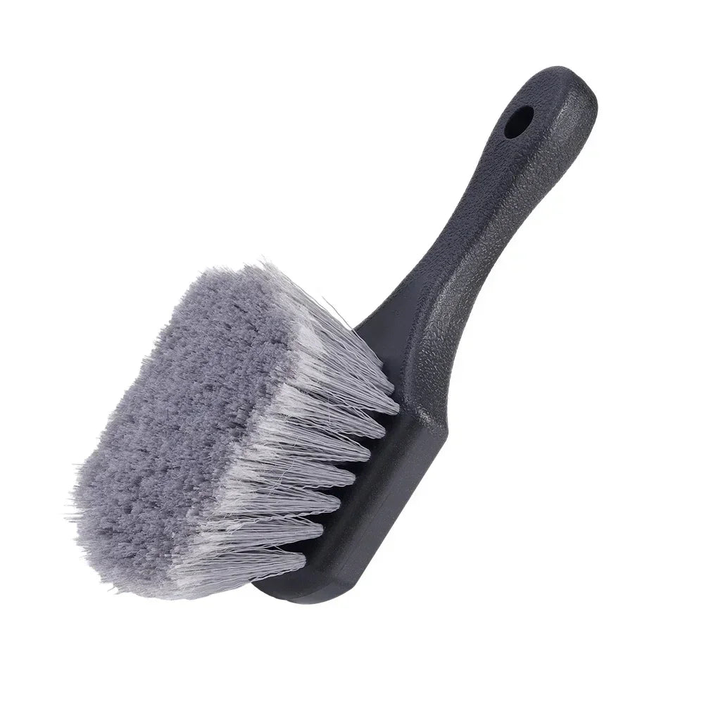 A gray compact car wheel and tire cleaning brush set with a handle and bristles.