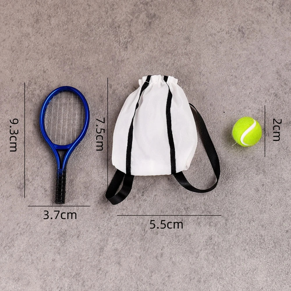 A white fabric bag with black stripes and a black strap is shown next to a blue hoop and a yellow tennis ball.