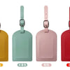 Four colored PU leather luggage tags in yellow, mint green, pink, and red displayed side by side.