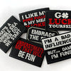 A collection of black embroidered iron-on patches with funny text such as I like my pork puddle and luck yourself