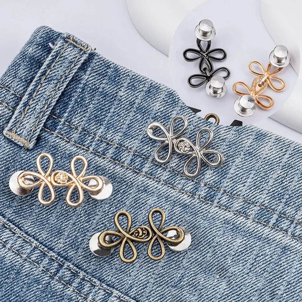 Gold and silver clover-shaped adjustable buckle for tightening waistbands on denim pants
