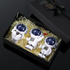 A set of four handcrafted astronaut figurine resin spaceman desk decor figures displayed in a black box.