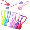 A set of three colorful magnetic silicone cable ties or cord organizers in various shades of pink, purple, and green.