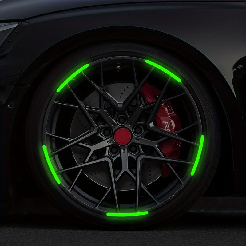 Close-up of a car wheel with bright green reflective stickers illuminating the spokes and rim.