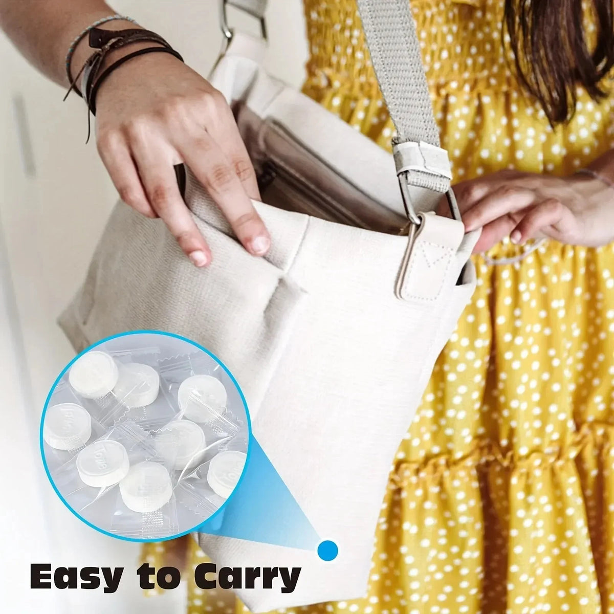 A hand is holding a beige disposable towel bag with a strap, showing the easy to carry feature.
