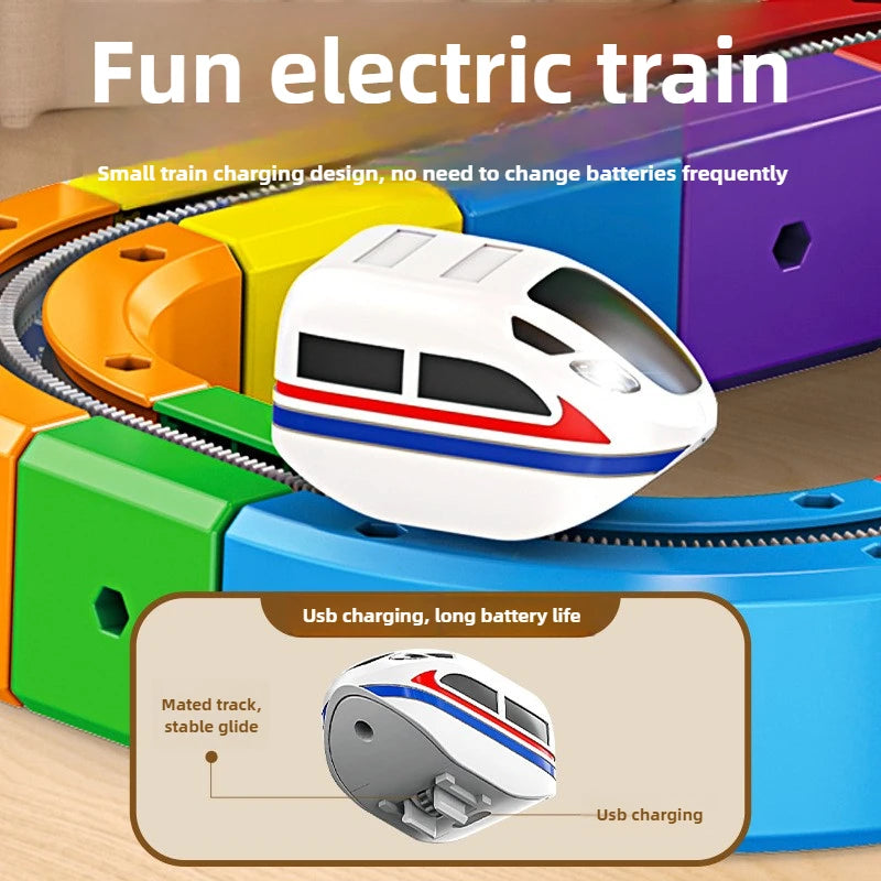 A white electric train engine is shown being charged via USB on a magnetic track set.