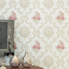 Close-up of floral wallpaper featuring pink and green roses on a light background, displayed next to a mirror and decorative 