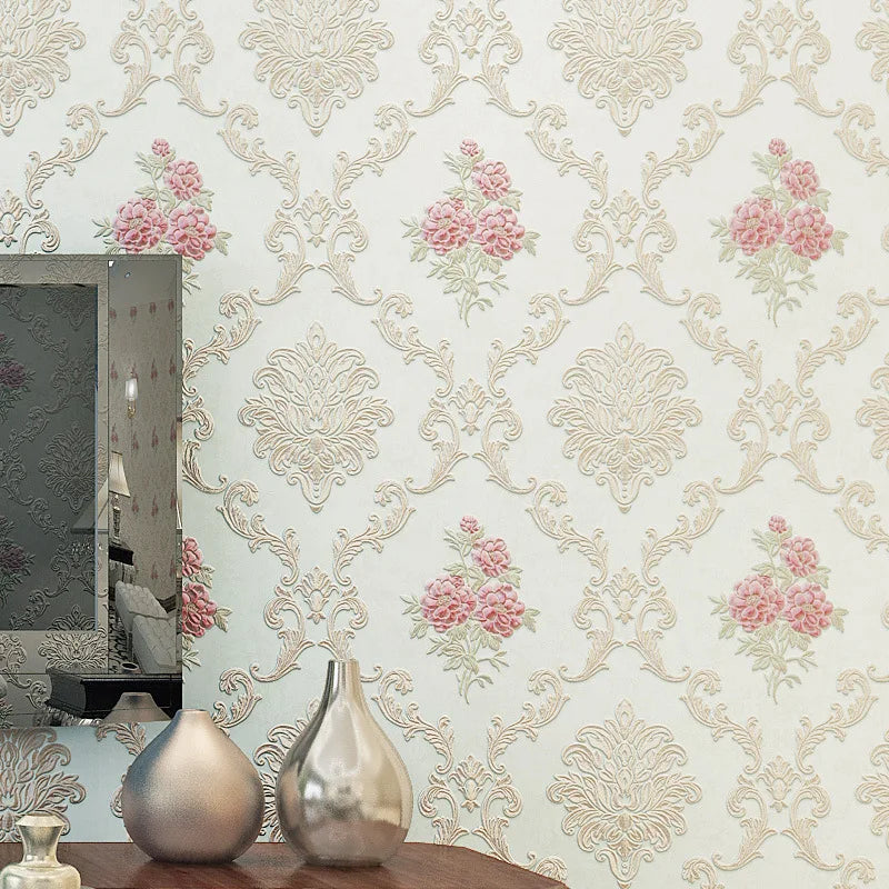 Close-up of floral wallpaper featuring pink and green roses on a light background, displayed next to a mirror and decorative 
