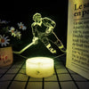 A night light featuring a 3D illusion of a hockey player on a transparent base.